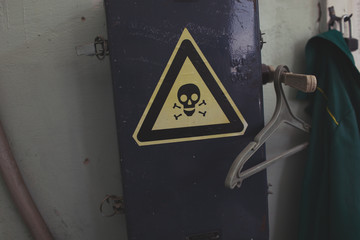 Workshop interior in Pripyat city, Chernobyl Exclusion Zone, Ukraine.Warning sign