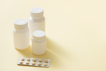 Bottles of medicines and pills in a blister pack.