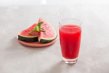 Watermelon juice, watermelon slices and mint leaves.