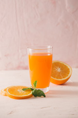 Isolated orange juice with slices of oranges on white background. 100 percent fresh and organic. Sweet juicy cocktail in glass. Natural antioxidant.