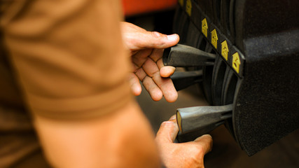 Technician's hand is controlling the lifting crane on the car. © sarawutnirothon