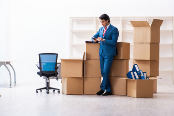 Young handsome businessman moving to new workplace 