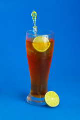 Glass of iced lime tea on blue background