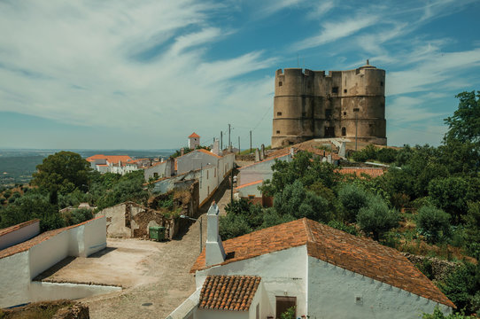 People walking up a street at the Castle of Evoramonte