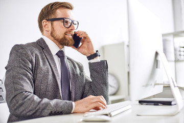 Mid age businessman working on computer at the office