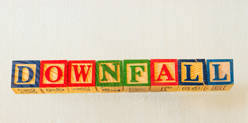 The term downfall visually displayed on a clear background using colorful wooden blocks image in landscape format with copy space