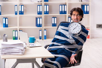 Young tied male employee in the office 