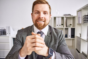 Mid age businessman talking on video call at the office