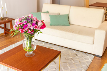 Floral arrangement  of roses and carnations decorating the living room of the house