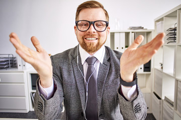 Mid age businessman talking on video call at the office