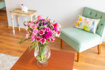 Floral arrangement  of roses and carnations decorating the living room of the house