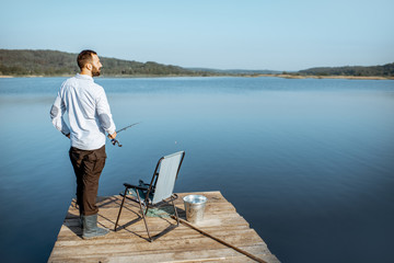 Man fishing on the lake during the mornign light