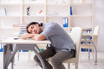 Young male student preparing for exams at home 