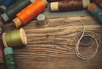 spool of thread, a thimble and a sewing needle