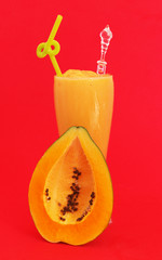 Fototapeta na wymiar Papaya smoothie and papaya fruit on red background