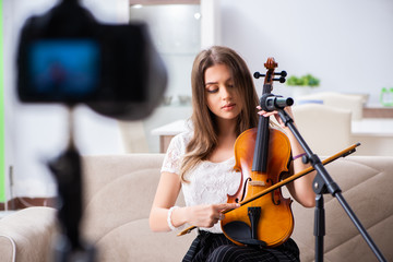 Female beautiful blogger playing violin