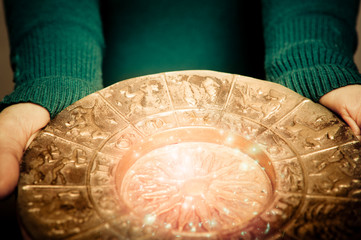 a woman fortune teller keeping gold zodiac like astrology concept 