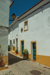Old colorful houses in a deserted alley at Elvas