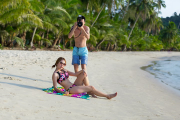 Fototapeta na wymiar Woman and man , couple lover playing on the beach at tropical sea with they honeymoon vacation.