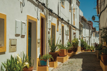 Old colorful houses and signpost indicating the Castle in an alley of Elvas