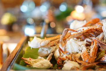 steamed blue crab or horse crab orange on wood tray and banana leaf for lunch or dinner serve on...