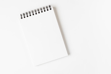 Open notebook on a spiral on a light background. Place for text. The concept of learning, sketch, writing. Flat lay, minimalism, top view, design.