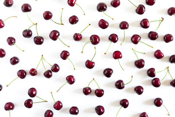 Obraz na płótnie Canvas Cherry pattern. Ripe cherry berries on white background. Flat lay, top view, copy space