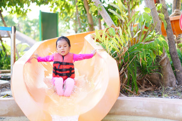 Asian child cute or kid girl swimming wear life jacket and smiling enjoy with happy fun playing...
