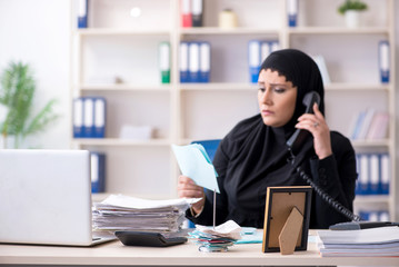 Female employee bookkeeper in hijab working in the office 