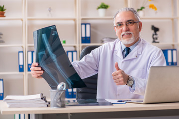 Aged male doctor radiologist in the clinic 