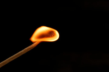 burning match with red, orange ,yello fire isolated on black background