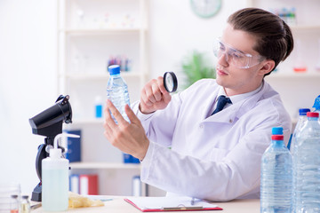 Young male chemist experimenting in lab