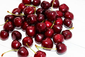 Fresh cherry on wooden white background. Fresh ripe cherries. Sweet cherries.