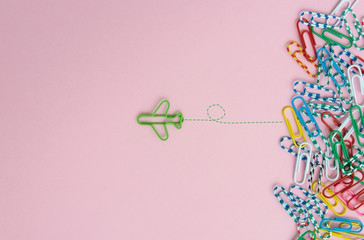 Business concept for group of stacked paperclip with another one green plane paperclip is point to...