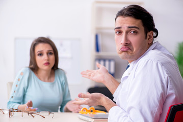 Young woman visiting male doctor oculist 