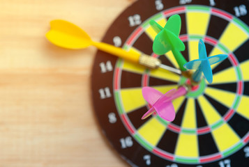 Close up green darts arrow on the target center of dartboard for business goal concept - Flay lay