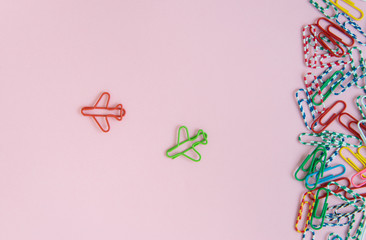 Business concept for group of stacked paperclip with another two red and green. plane paperclips are point to another direction as a team leadership and difference thinking