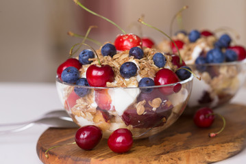Food. Fruit salad with cherries, blueberry, muesli, yogurt
