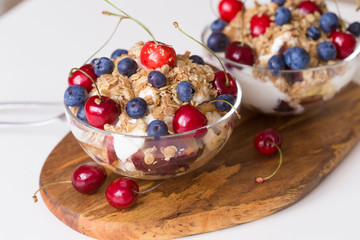 Food. Fruit salad with cherries, blueberry, muesli, yogurt