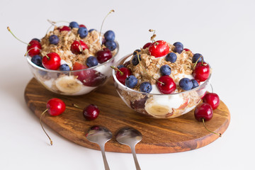 Food. Fruit salad with cherries, blueberry, muesli, yogurt