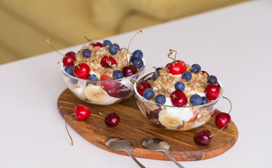 Food. Fruit salad with cherries, blueberry, muesli, yogurt