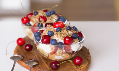 Food. Fruit salad with cherries, blueberry, muesli, yogurt