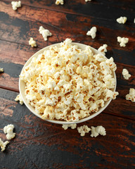 bowl of salty popcorn on wooden table