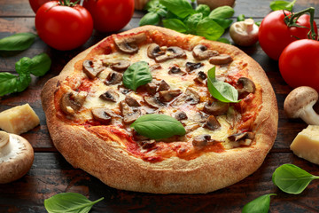 Hot Mushroom Pizza with basil, tomatoes, mozzarella and parmesan cheese on wooden table. ready to eat. vegetarian food