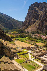 View from Pumatallis terraces, in the Ollantaytambo archaeological site, of the Inca town: amazing ancient city, ruins and the beautiful green valley. Travel destination in the Sacred Valley, Peru