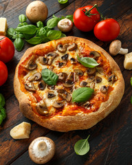 Hot Mushroom Pizza with basil, tomatoes, mozzarella and parmesan cheese on wooden table. ready to eat. vegetarian food