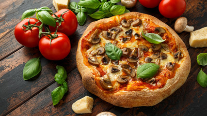 Hot Mushroom Pizza with basil, tomatoes, mozzarella and parmesan cheese on wooden table. ready to eat. vegetarian food