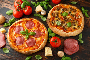 Homemade Pepperoni, Salami, mushroom Pizza with basil, tomatoes, cheese on wooden table. ready to eat