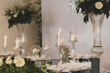 flowers and candles on the decorated table