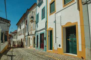 Alley of old colorful houses with worn plaster wall
